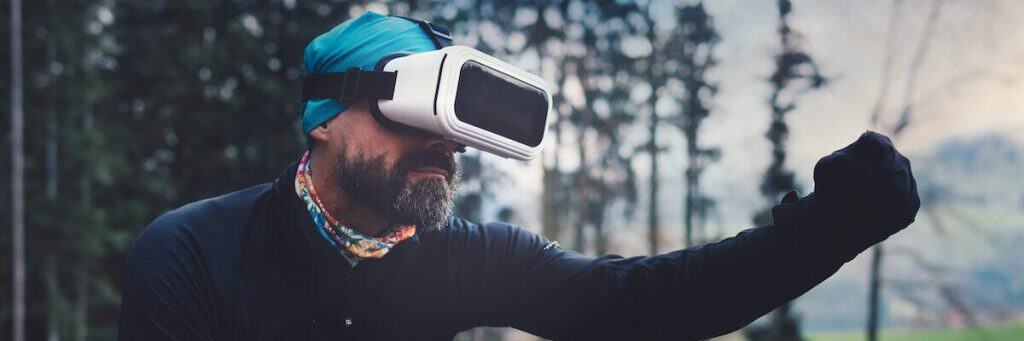 A bearded gamer enjoying augmented reality games through his goggles.