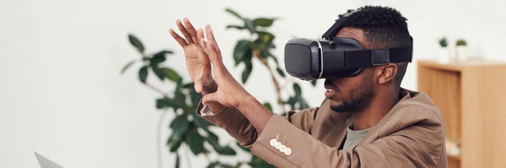 A man interacting with the output of augmented reality games in his living room.