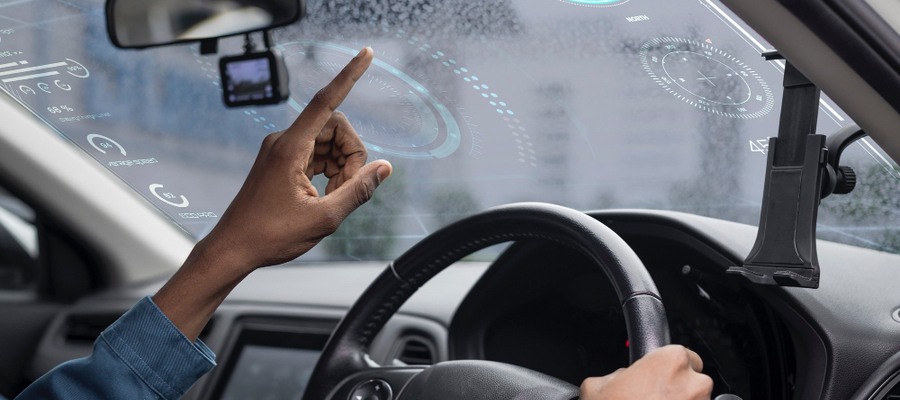 A driver accessing some of the automated vehicles features on the windshield.