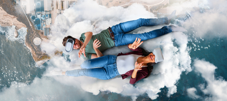 A man and woman similate floating on a cloud while using virtual reality games.