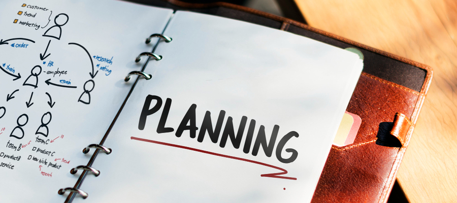 A flow diagram of business planning on a notebook.