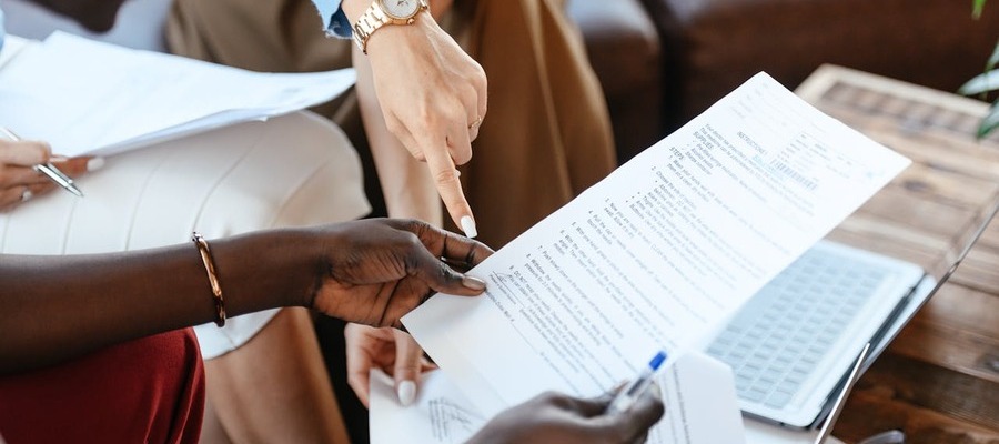A team review a printout of a page from an AI business plan generator.