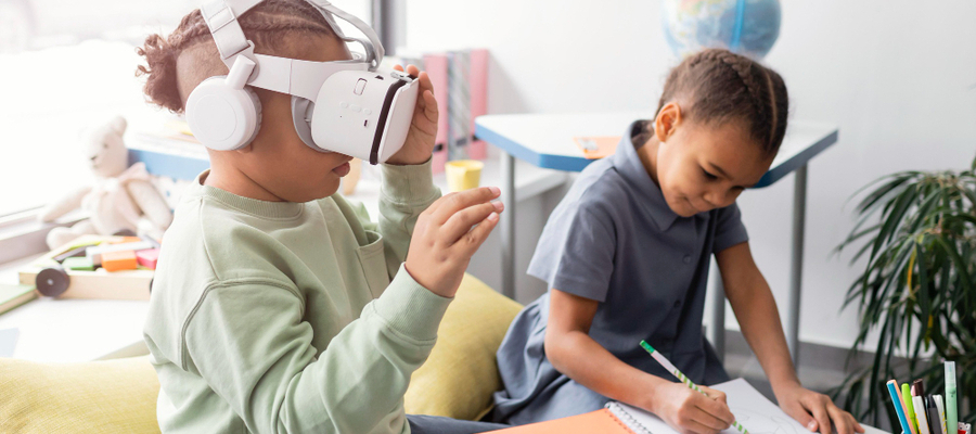 A small girl interacts with augmented reality in education while her friend writes down on a book.