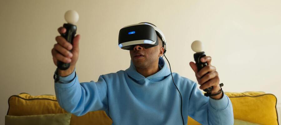 A boy with goggles connected to pointing gadgets enjoying games with augmented reality.